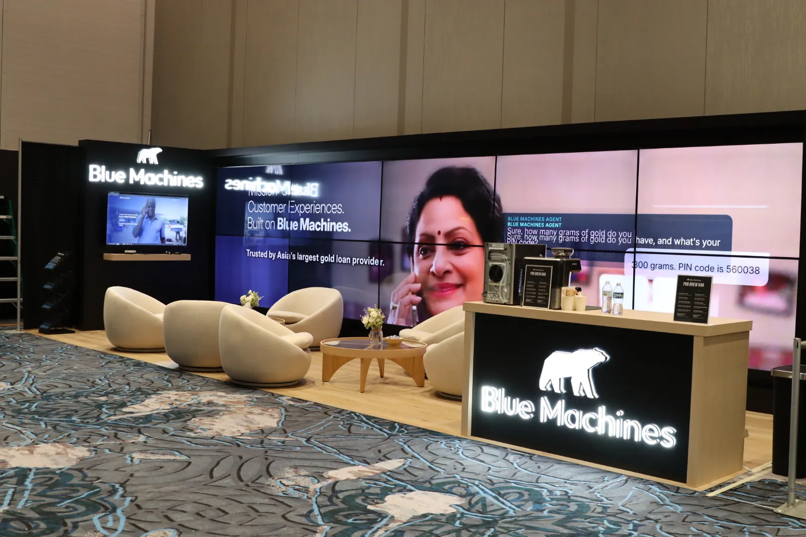Custom Blue Machines exhibit with a seamless LED video wall and lounge seating, built by Vegas Vogue Expo at Caesars Forum, Las Vegas